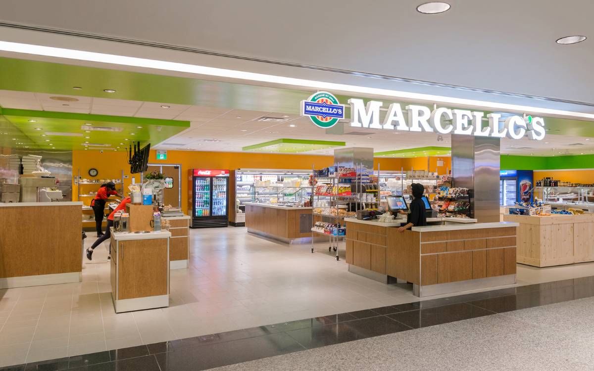 A Marcello's Market & Deli store with its deli counter and grab-and-go fridges